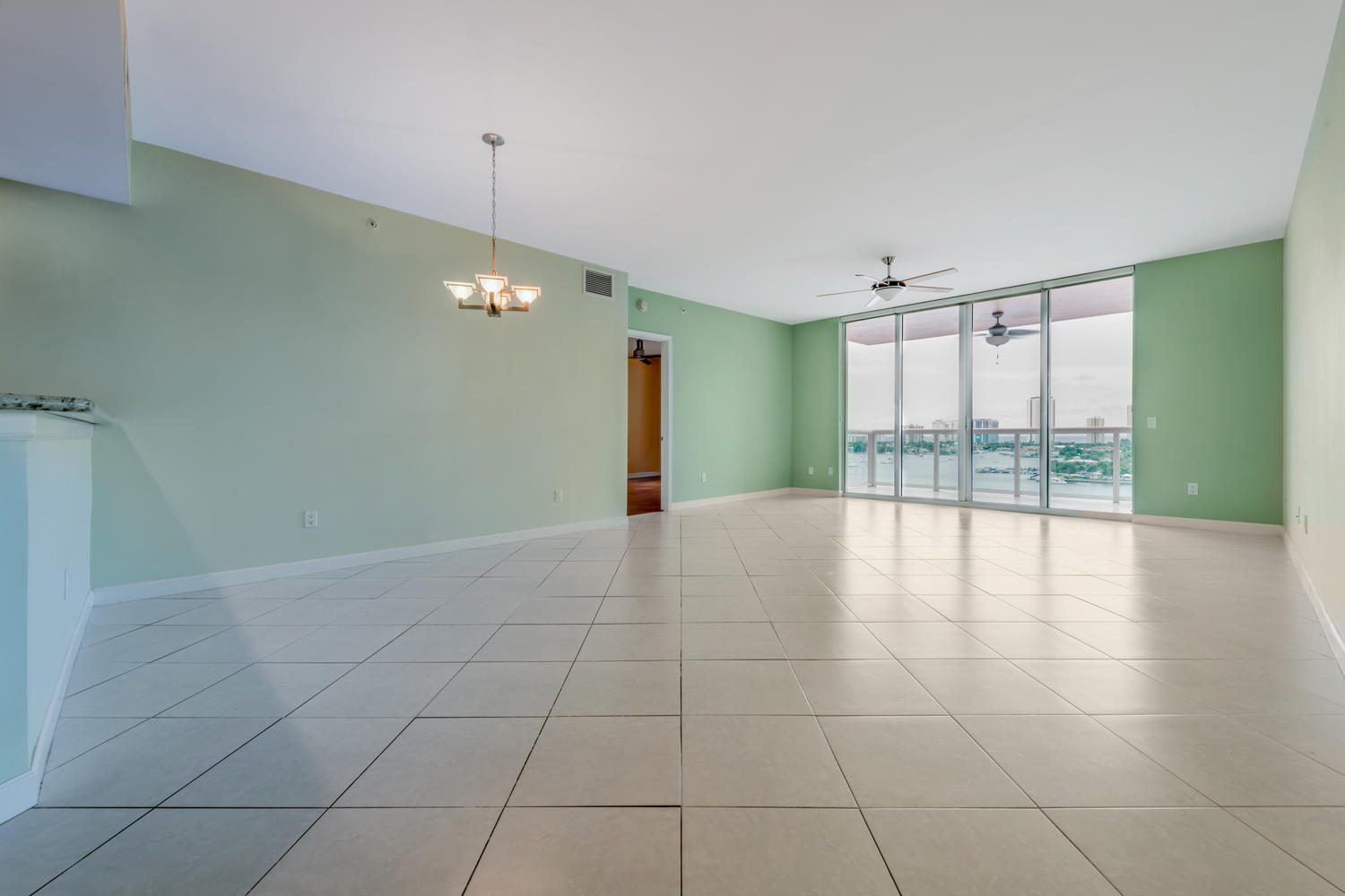 2640 Lake Shore Drive, Unit 1011 Riviera Beach, FL 33404 - Photo 8 of 60 a view of an empty room with glass door