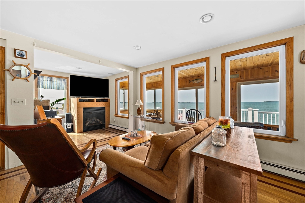 91 Shellton Road Quincy, MA 02169 - Photo 14 of 31 a living room with furniture a flat screen tv and a large window