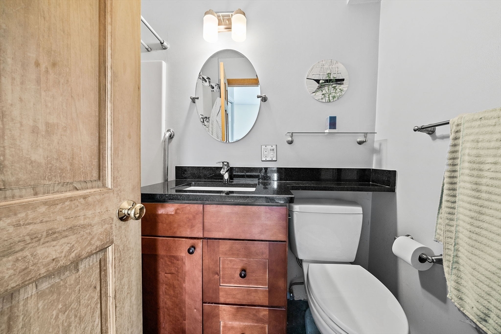 91 Shellton Road Quincy, MA 02169 - Photo 18 of 31 a bathroom with a toilet a sink and mirror