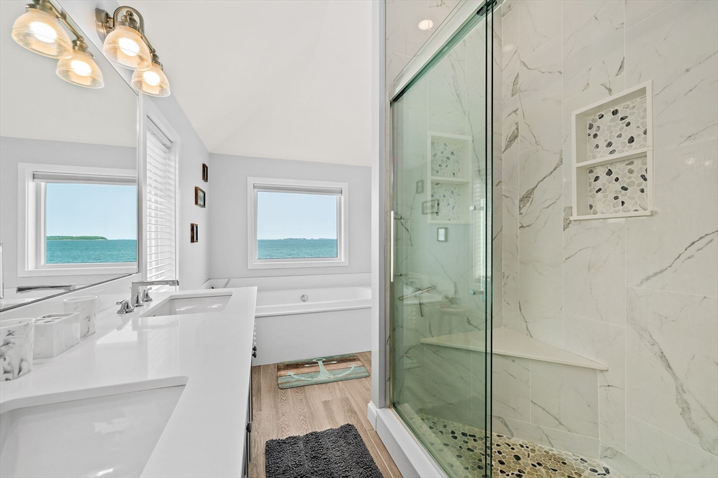 91 Shellton Road Quincy, MA 02169 - Photo 21 of 31 a bathroom with a bathtub a sink and a large mirror
