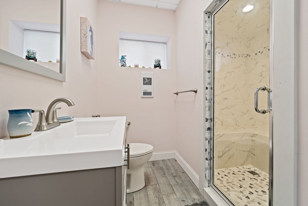 91 Shellton Road Quincy, MA 02169 - Photo 22 of 31 a bathroom with a sink a toilet a shower and a mirror