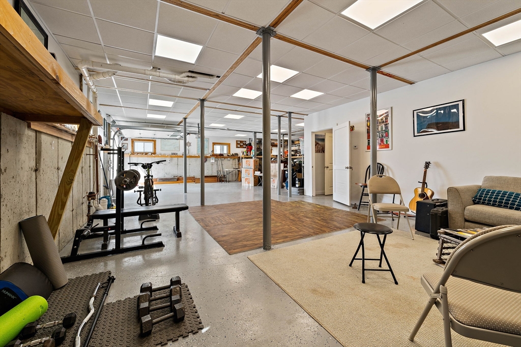 91 Shellton Road Quincy, MA 02169 - Photo 24 of 31 a gym room with lots of chairs and a chandelier