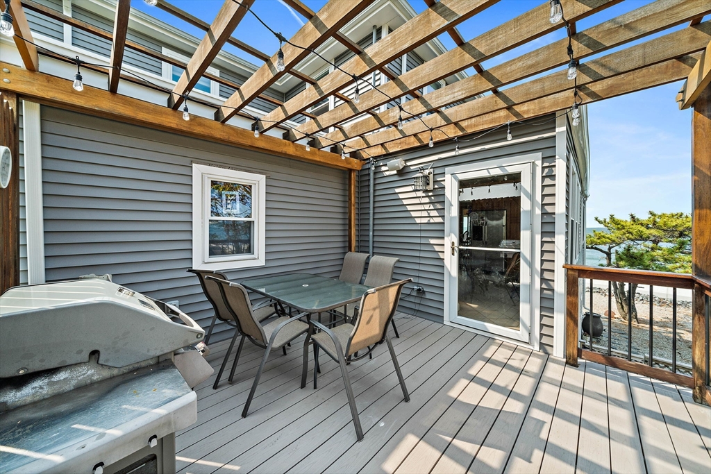 91 Shellton Road Quincy, MA 02169 - Photo 27 of 31 a roof deck with a dining table and chairs with wooden floor