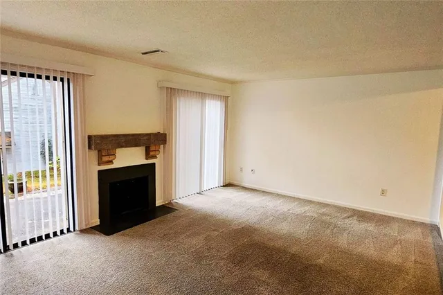 an empty room with fireplace