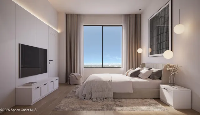 a bedroom with a large bed and a flat screen tv