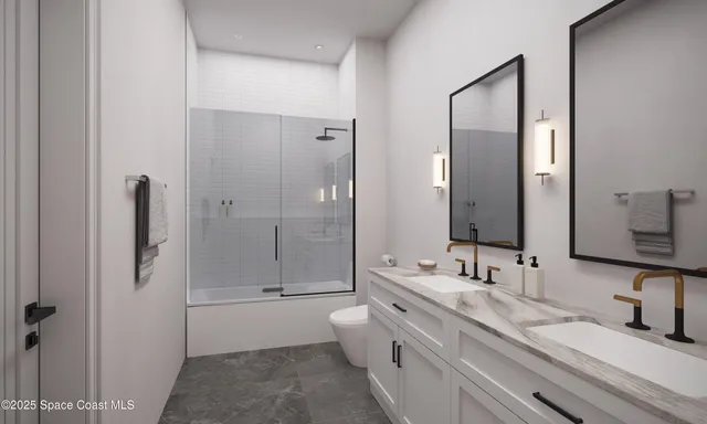 a bathroom with a granite countertop tub sink toilet and mirror