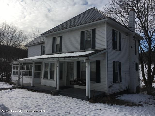 1443 Marcy Road Springville, PA 18844 - Photo 1 of 13 a view of a white house with large windows