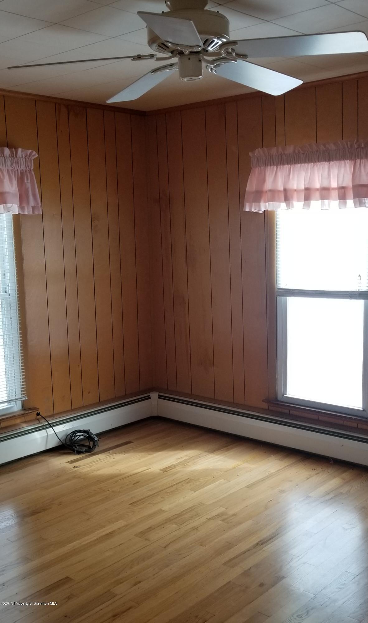 1443 Marcy Road Springville, PA 18844 - Photo 7 of 13 an empty room with wooden floor and windows