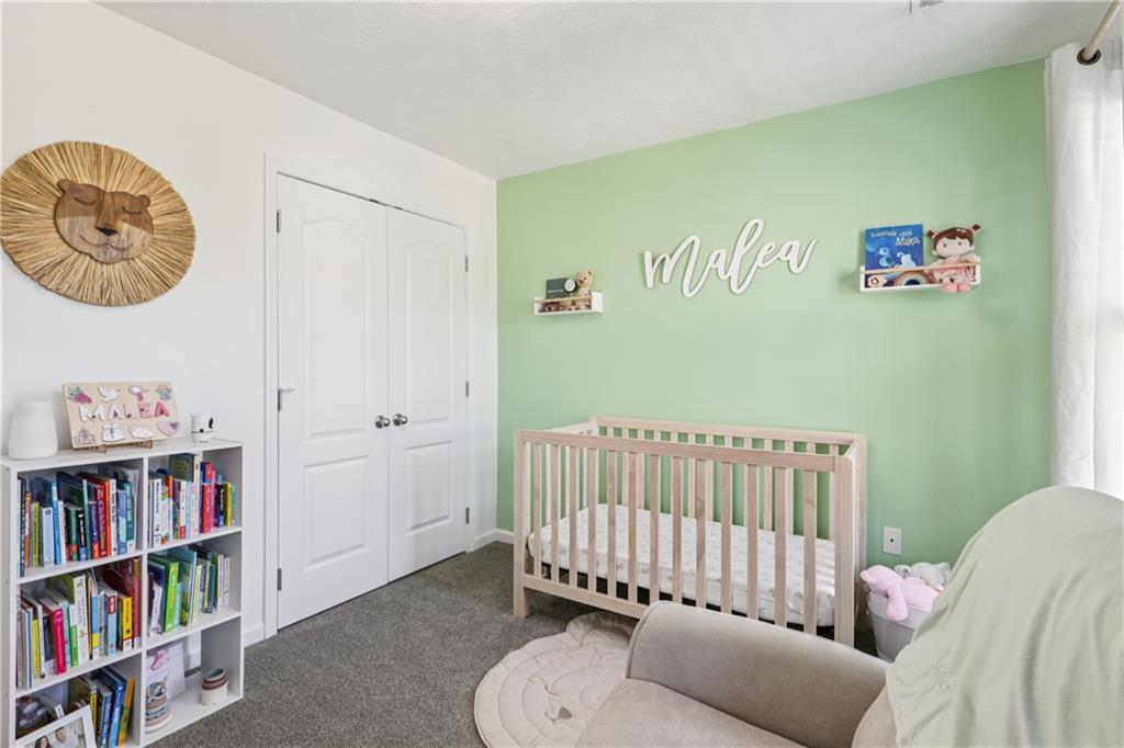 19 Truman Circle McKees Rocks, PA 15136 - Photo 25 of 45 a bedroom with a baby bed a couch and a book shelf