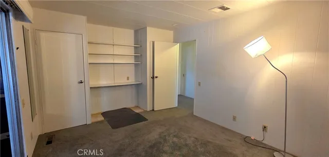 a bedroom with a bed and a mirror