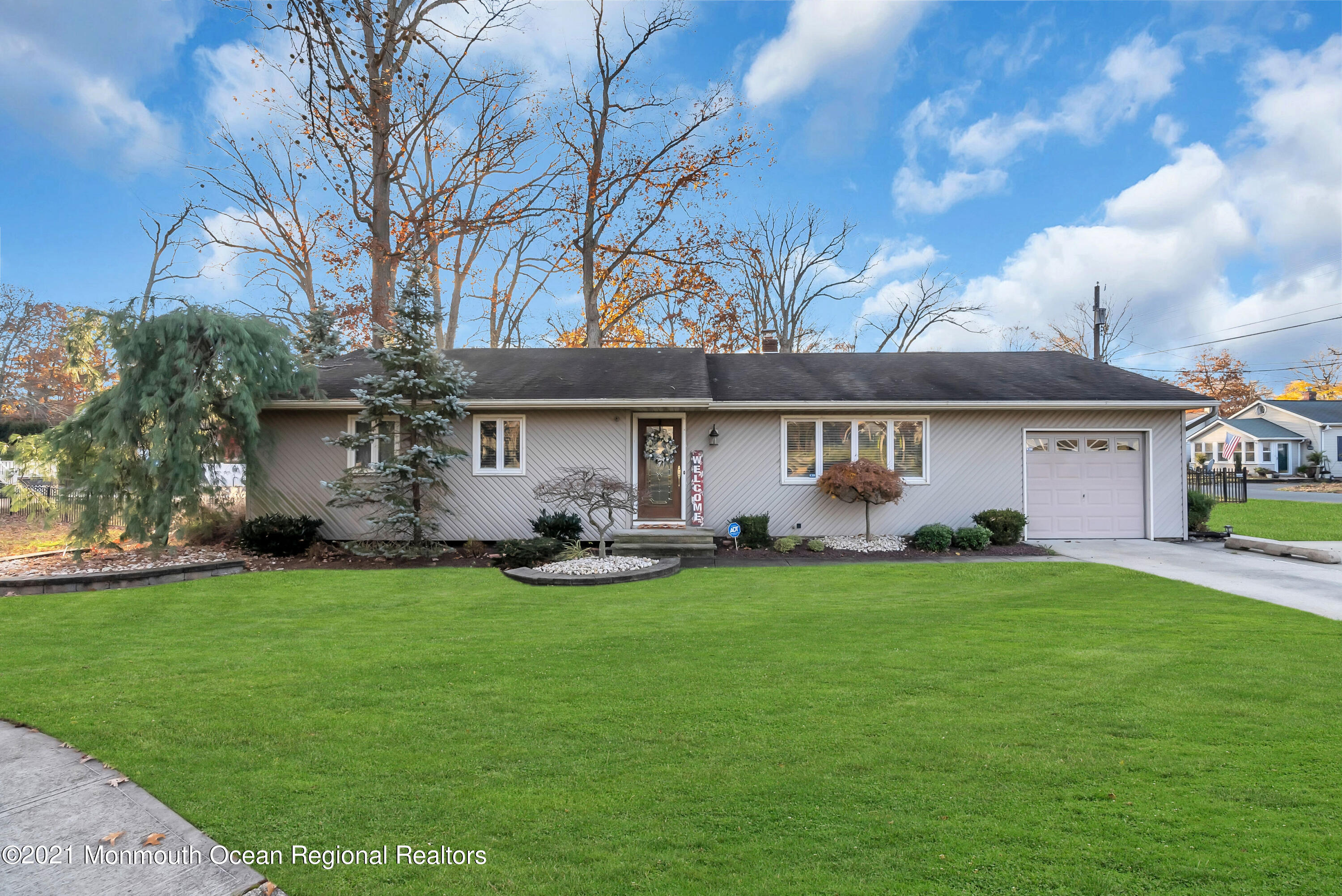 128 Whalepond Road Oakhurst, NJ 07755 - Photo 1 of 33 a front view of a house with a garden