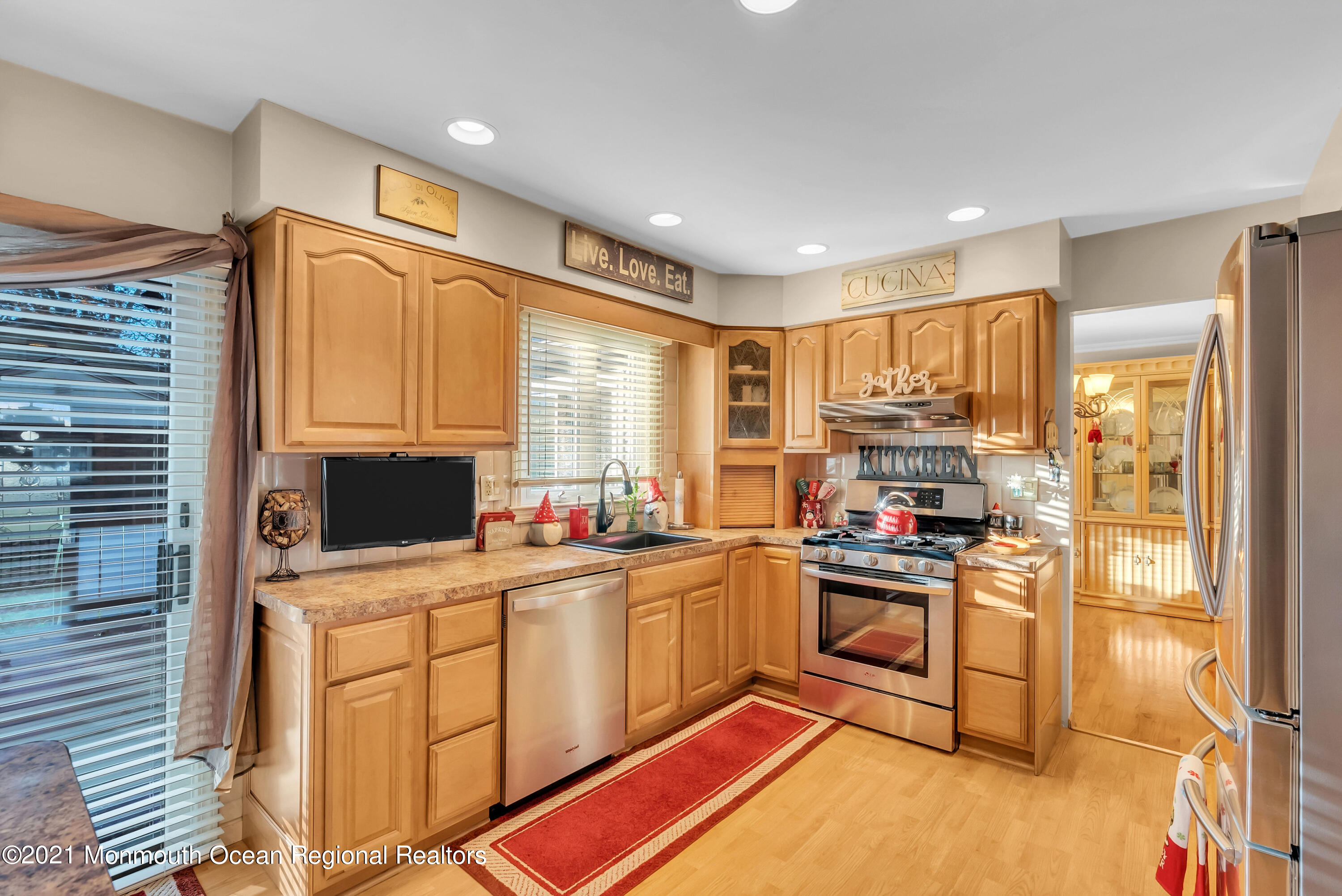 128 Whalepond Road Oakhurst, NJ 07755 - Photo 12 of 33 a kitchen with kitchen island granite countertop a sink appliances cabinets and a counter top space