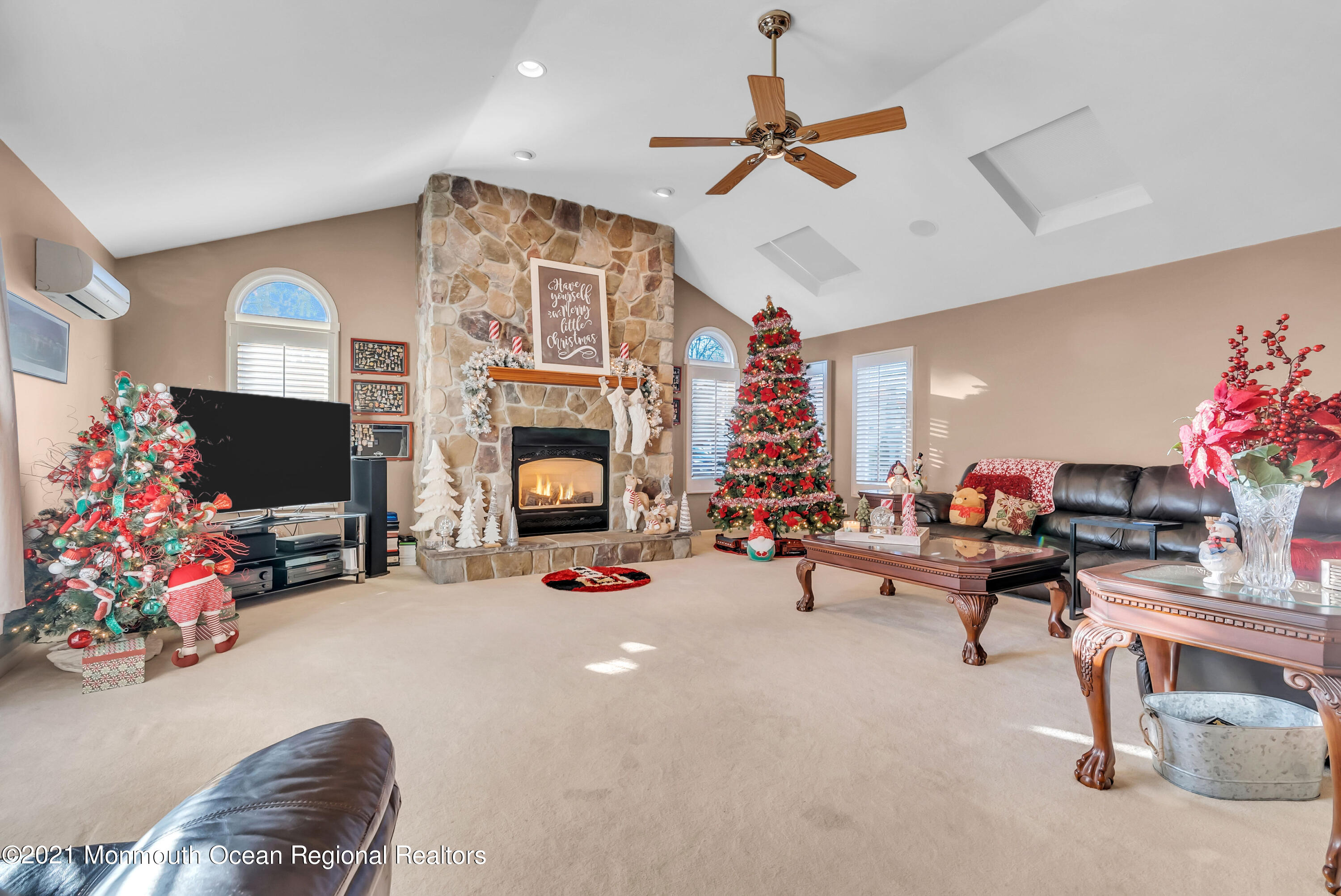 128 Whalepond Road Oakhurst, NJ 07755 - Photo 9 of 33 a living room with furniture a flat screen tv and a fireplace