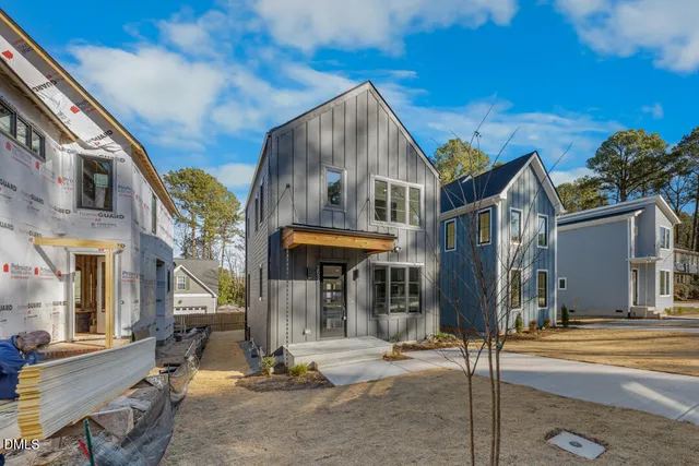 a kitchen with stainless steel appliances granite countertop a refrigerator a sink dishwasher a stove and a refrigerator with wooden floor