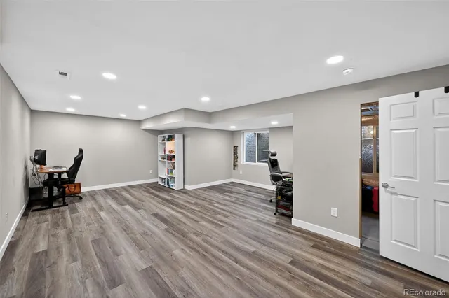 a view of empty room with wooden floor