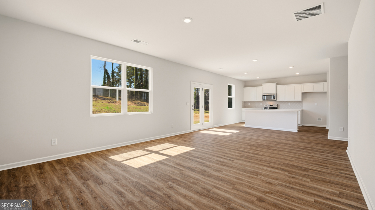 8578 Seabiscuit Road Lithonia, GA 30058 - Photo 16 of 30 a view of a kitchen with wooden floor and windows