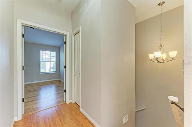 a view of empty room with wooden floor and ceiling fan