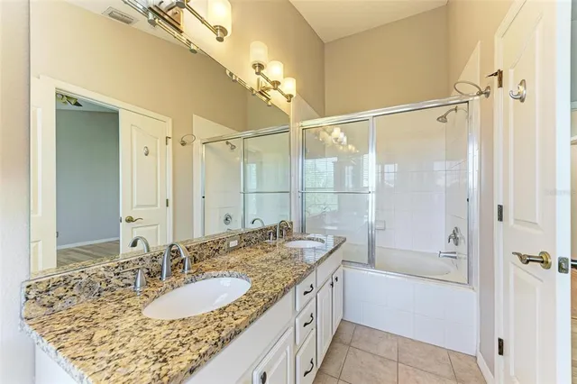 a bathroom with a sink a mirror and a shower