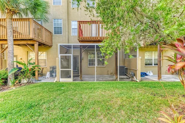 an aerial view of a house with a yard and lake view