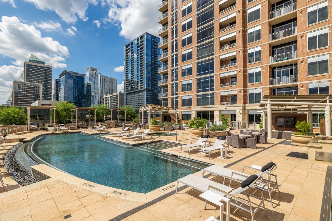 101 Colorado Street, Unit 2601 Austin, TX 78701 - Photo 1 of 12 a view of a swimming pool with a lounge chairs