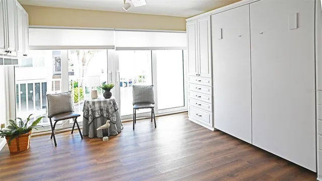 a bathroom with a granite countertop toilet a sink a shower and a window