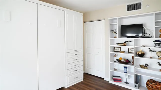 a view of staircase with wooden floor and white walls