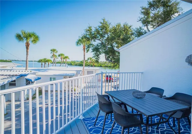 an aerial view of residential houses with outdoor space and lake view