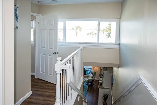a bedroom with a bed and a large mirror with a window