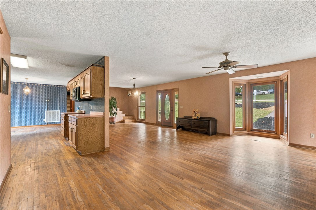 133 Pinetree Lane Easley, SC 29640 - Photo 17 of 28 Warm hardwood flooring flows seamlessly through this open-concept layout containing a prominent bay window.