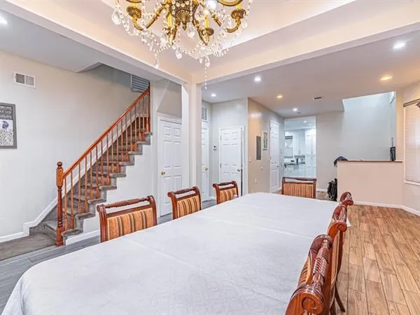 a bedroom with a large bed and a chandelier