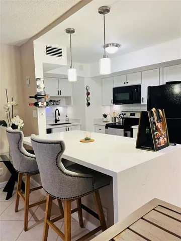 a kitchen with stainless steel appliances kitchen island wooden cabinets and refrigerator