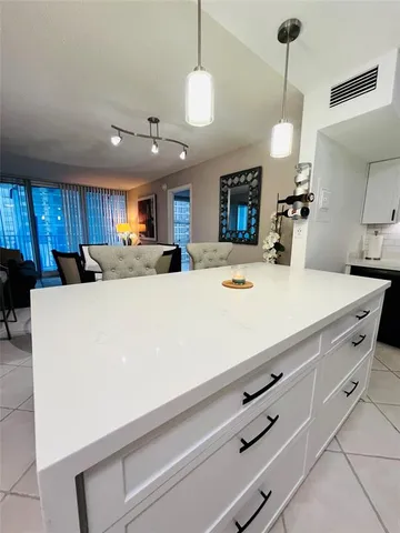 a kitchen with kitchen island a stove and a center island