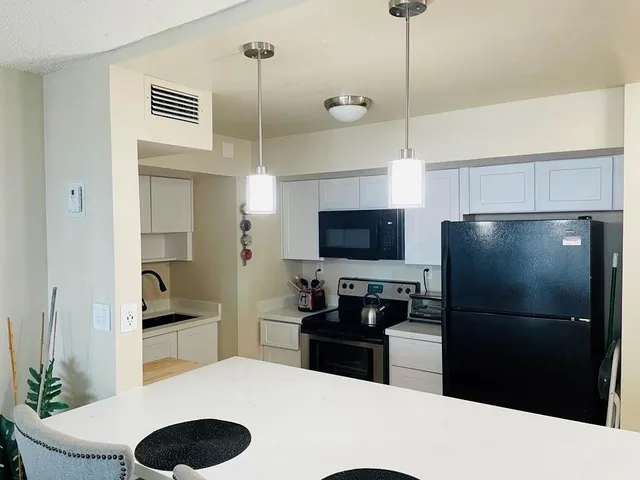 a kitchen with a refrigerator and a sink