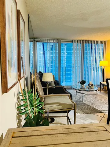 a living room filled with furniture and a potted plant