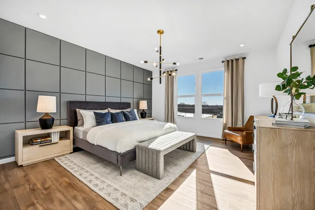 a bed room with a bed window and potted plant