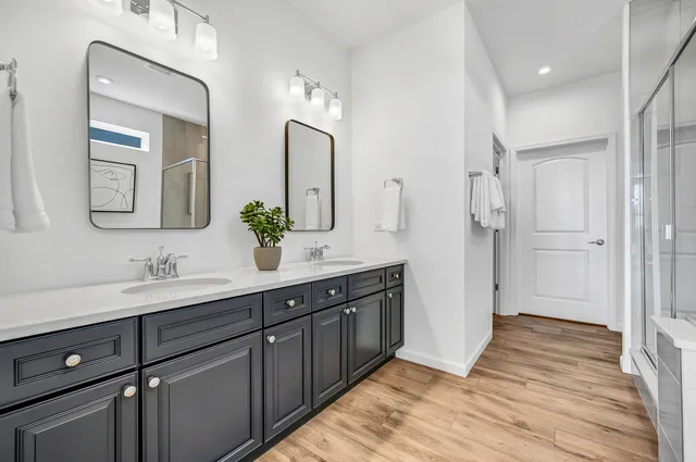a spacious bathroom with a double vanity sink and a mirror