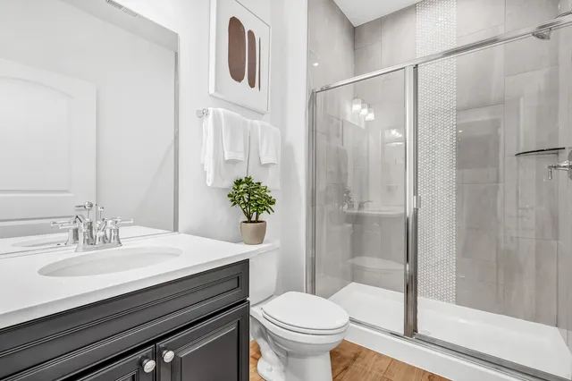 a bathroom with a sink toilet and shower