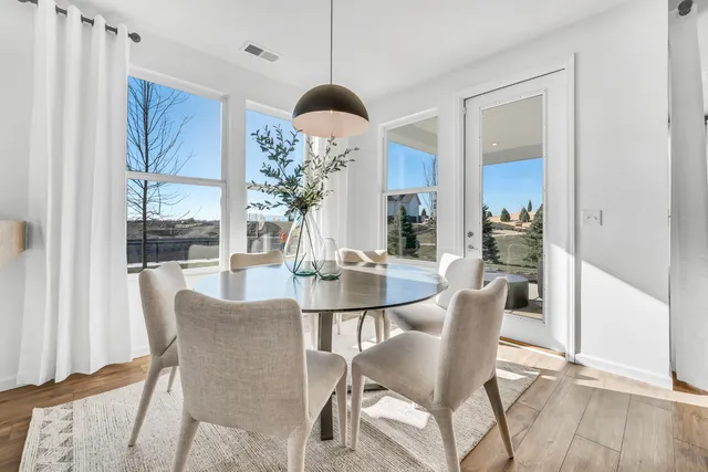 a dining room with furniture a chandelier and wooden floor