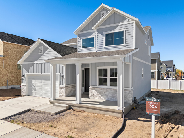 18 South Crimson Way, Unit 304 Mapleton, UT 84664 - Photo 2 of 17 View of front of home featuring board and batten siding, covered porch, stone siding, and a shingled roof