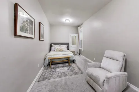 a bedroom with a bed and a couch