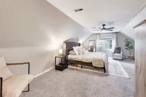 a bedroom with bed and a chandelier