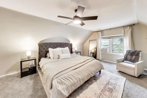 a spacious bedroom with a large bed and a couch