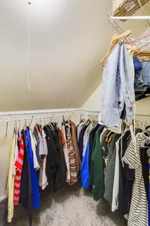 a view of walk in closet with clothes