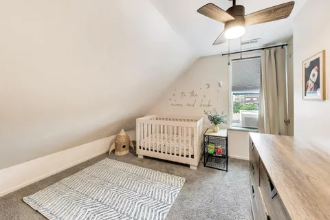 a bedroom with a bed and window