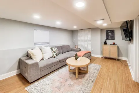 a living room with furniture and a wooden floor