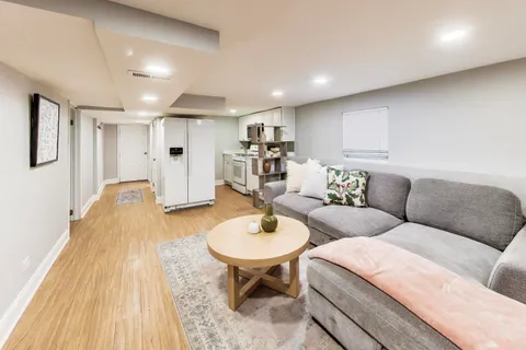 a living room with furniture and a wooden floor