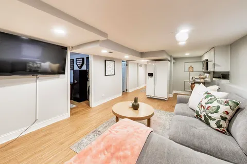 a living room with furniture and a wooden floor