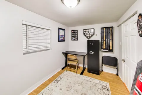 a bedroom with a bed and a chair with rug