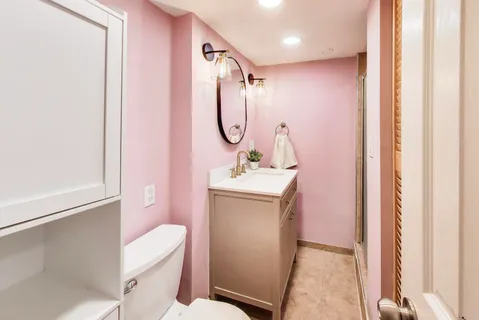 a bathroom with a sink a toilet and shower
