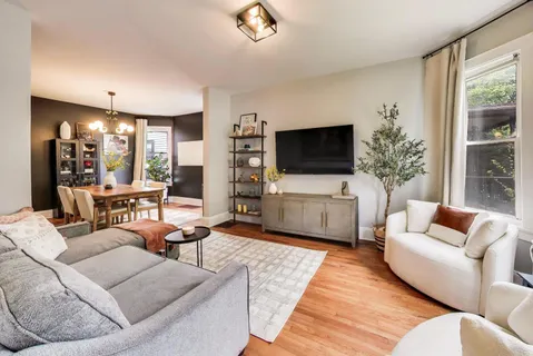a living room with furniture and a flat screen tv